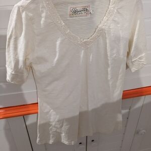 Small cream colored adventure shirt